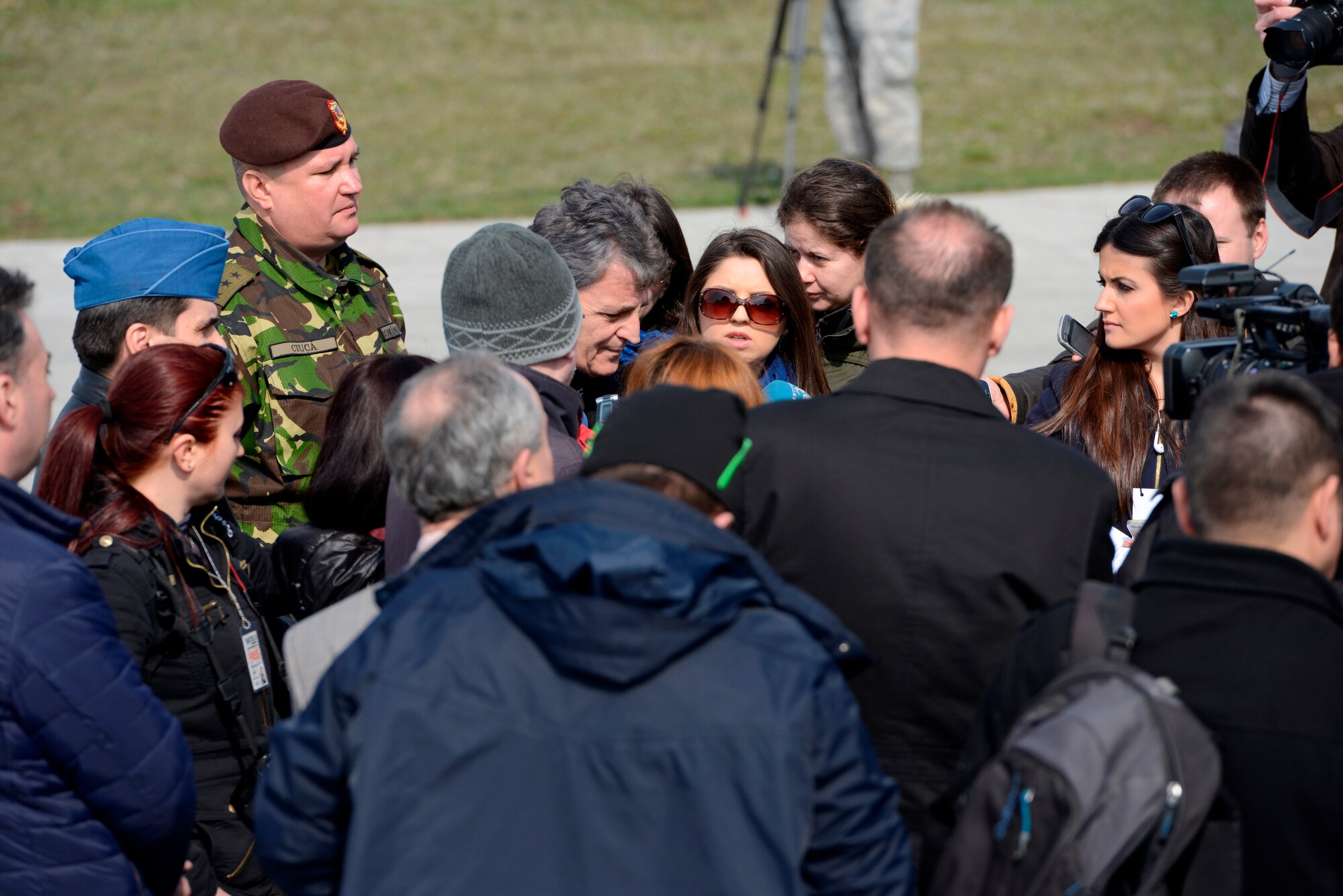 Romanian media members ask Romanian Minister of Defense Mircea Dusa questions as part of a media and distinguished visitor day at Campia Turzii, Romania, during Dacian Warhawk, March 22, 2015. More than 20 local and national Romanian media members were invited to witness the accomplishments of the Dacian Warhawk mission, a two-week training event designed to increase the interoperability between the two nations. (U.S. Air Force photo/Staff Sgt. Kris Levasseur)