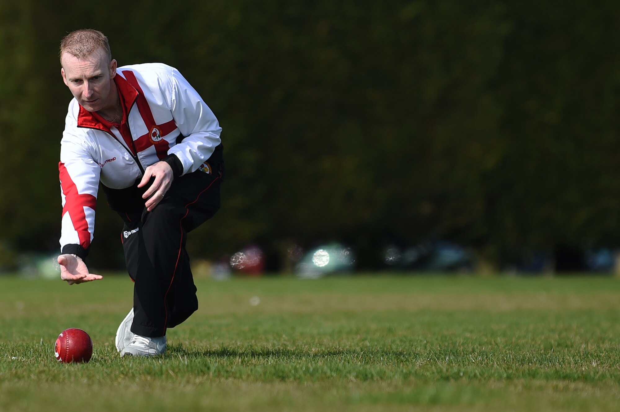 Nick Brett, 423rd Civil Engineer Squadron water and fuels shop chief, rolls a ball, called a “bowl” down the athletic field at RAF Alconbury, England, March 23, 2015. Currently, Brett is ranked as the number one indoor bowls champion of the world. (U.S. Air Force photo by Staff Sgt. Jarad A. Denton/Released)
