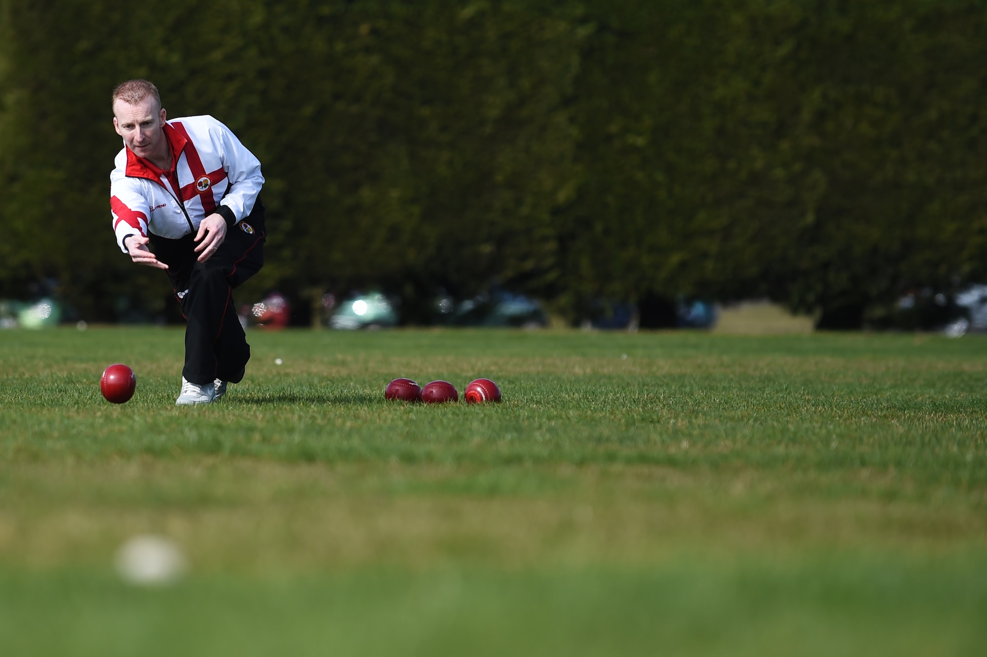 Nick Brett, 423rd Civil Engineer Squadron water and fuels shop chief, rolls a bowl along the athletic field at RAF Alconbury, England, March 23, 2015. Brett earned the title of World Indoor Bowls Champion, when he defeated six-time world champion, Alex Marshall, during the Co-operative Funeralcare Open, March 6, 2015. (U.S. Air Force photo by Staff Sgt. Jarad A. Denton/Released)