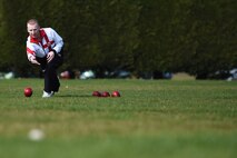 Nick Brett, 423rd Civil Engineer Squadron water and fuels shop chief, rolls a bowl along the athletic field at RAF Alconbury, England, March 23, 2015. Brett earned the title of World Indoor Bowls Champion, when he defeated six-time world champion, Alex Marshall, during the Co-operative Funeralcare Open, March 6, 2015. (U.S. Air Force photo by Staff Sgt. Jarad A. Denton/Released)
