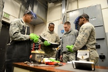 Senior Airman Corbin Worley, 91st Missile Operations Squadron facility maintenance instructor, trains students on diesel electric unit oil system servicing and repair on Minot Air Force Base, N.D., March 3, 2015. FMT instructors provide instruction to produce competent facilities maintenance technicians that are able to perform periodic maintenance, troubleshoot, and repair of the diesel-electrical units and environmental control systems that sustain unmanned launch facilities. (U.S. Air Force photo/Senior Airman Brittany Y. Bateman)