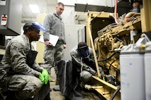 Senior Airman Corbin Worley, 91st Missile Operations Squadron facility maintenance instructor, trains students on diesel electric unit oil system servicing and repair on Minot Air Force Base, N.D., March 3, 2015. FMT instructors provide instruction to produce competent facilities maintenance technicians that are able to perform periodic maintenance, troubleshoot, and repair of the diesel-electrical units and environmental control systems that sustain unmanned launch facilities. (U.S. Air Force photo/Senior Airman Brittany Y. Bateman)