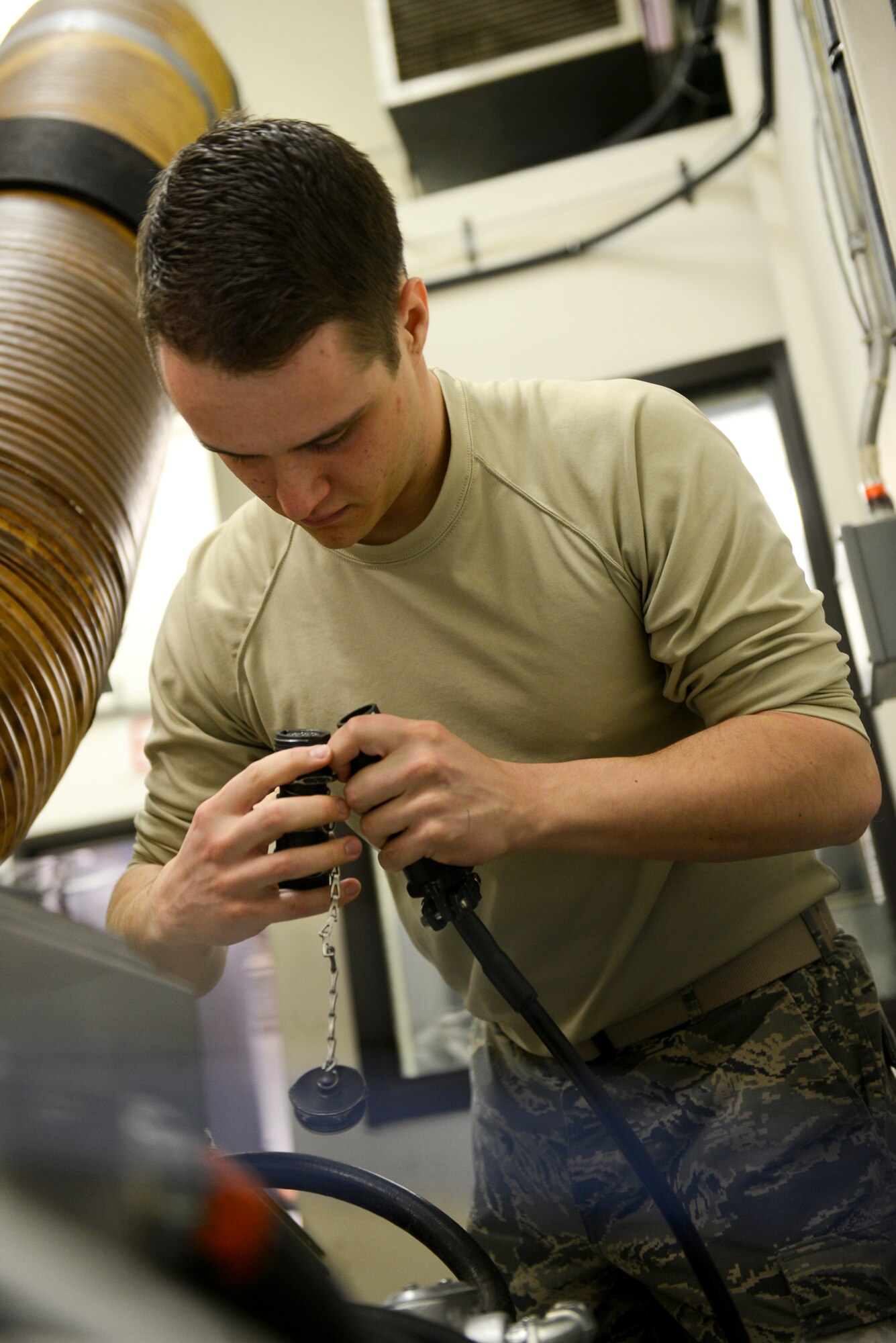 Airman 1st Class Jacob O’Leary, 91st Missile Operations Squadron facilities maintenance team member, performs a periodic maintenance inspection and repair of the air handler during training on Minot Air Force Base, N.D., March 3, 2015. FMT instructors provide instruction to produce competent facilities maintenance technicians that are able to perform periodic maintenance, troubleshoot, and repair diesel-electrical units and environmental control systems that sustain unmanned launch facilities. (U.S. Air Force photo/Senior Airman Brittany Y. Bateman)