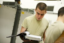 Airman 1st Class Thomas Bozeman, 91st Missile Operations Squadron facilities maintenance team member, reads technical orders during training on Minot Air Force Base, N.D., March 3, 2015. FMT instructors provide instruction to produce competent facilities maintenance technicians that are able to perform periodic maintenance, troubleshoot, and repair diesel-electrical units and environmental control systems that sustain unmanned launch facilities. (U.S. Air Force photo/Senior Airman Brittany Y. Bateman)