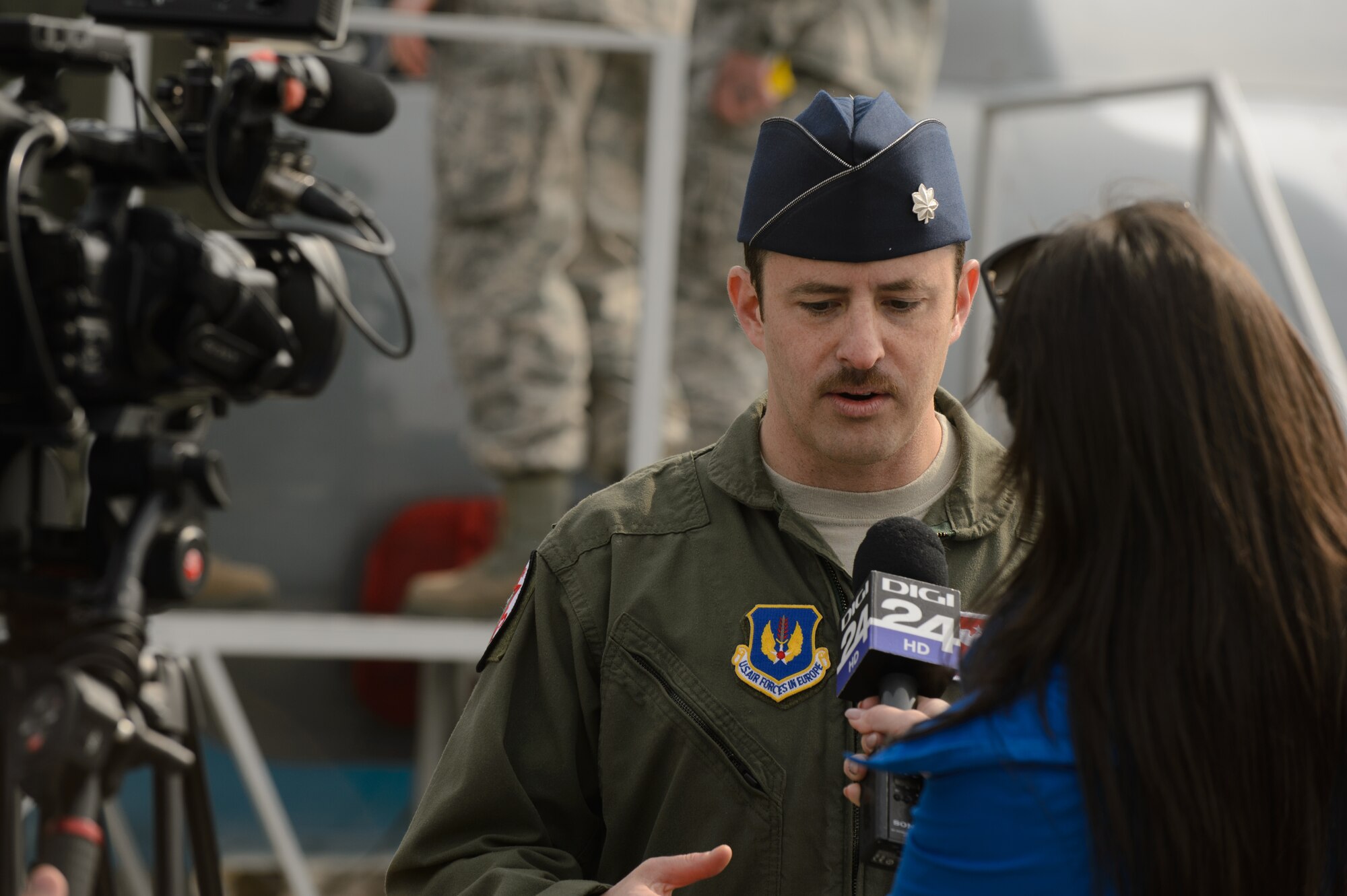 Lt. Col. Ryan Nudi, 52nd Fighter Wing chief of safety, gives an interview to a member of the local media at Campia Turzii, Romania, March 22, 2015. U.S. and Romanian Airmen hosted a media and distinguished visitor day in order to showcase the efforts during Dacian Warhawk, a two-week training mission designed to increase the interoperability between the two nations. (U.S. Air Force photo/Staff Sgt. Armando A. Schwier-Morales)