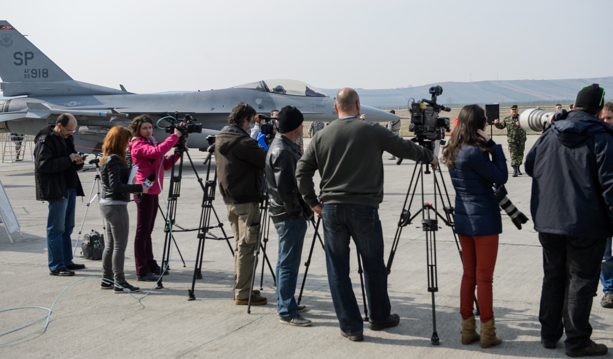 Members of local and national Romanian media view an F-16CJ Fighting Falcon static display at Campia Turzii, Romania, March 22, 2015. The 52nd Fighter Wing, 435th Air Ground Operations Wing and Romanian 71st Base Wing hosted a media and distinguished visitor day to showcase the accomplishments of Dacian Warhawk, a two-week training mission designed to increase the interoperability between the two nations. (U.S. Air Force photo/Staff Sgt. Armando A. Schwier-Morales)