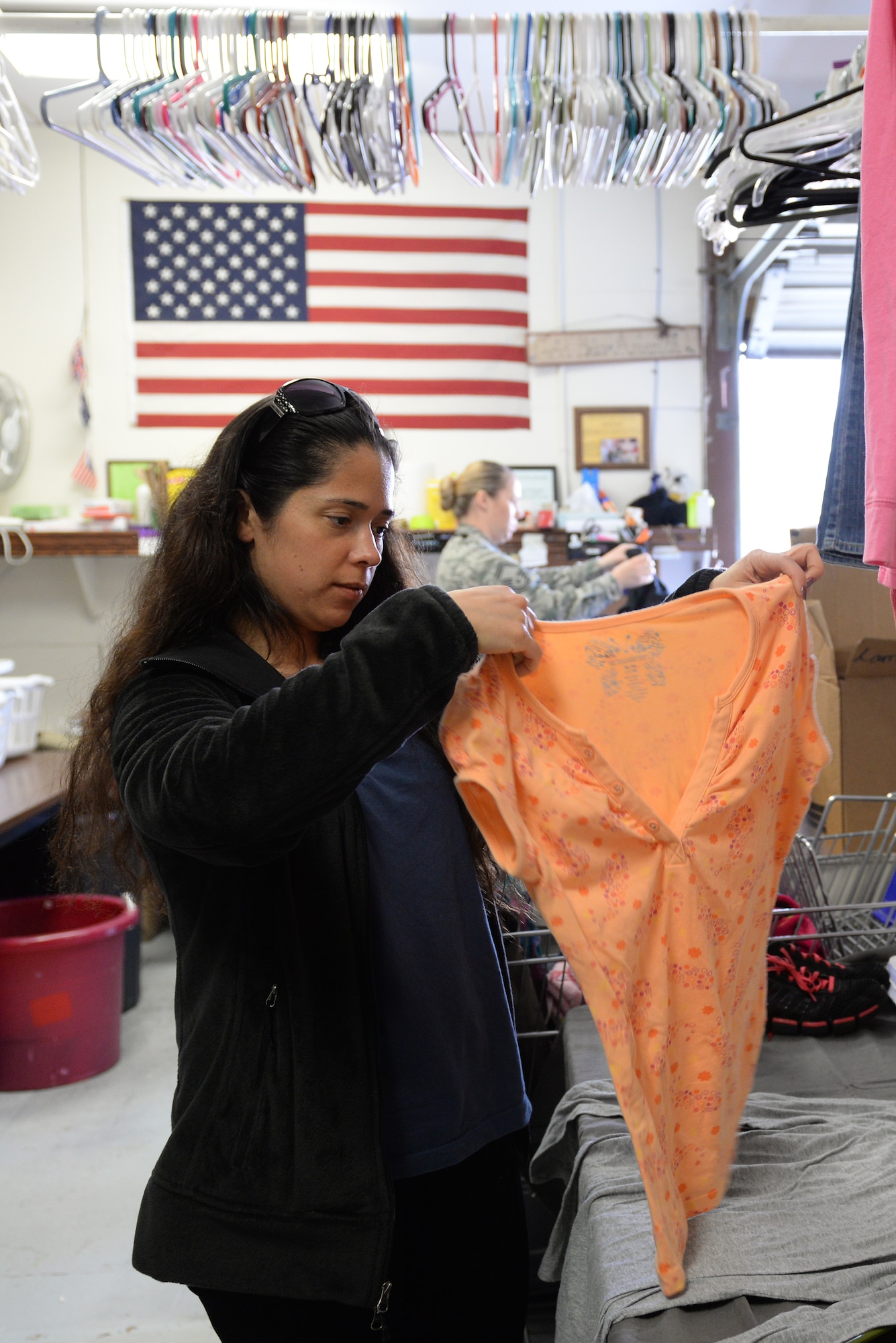 Staff Sgt. Regina Parr sorts and hangs women’s clothing at the Airman’s Attic on Scott Air Force Base, Illinois on March 12, 2015. The Airman’s Attic depends on volunteers to accept donations, sort them, place them on shelves, and assist customers. Everything at the Airman’s Attic is 100 percent free. Parr is a member of Command and Control at the 618th Air Operations Center. (U.S. Air Force photo by Senior Airman Sarah Hall-Kirchner/Released)