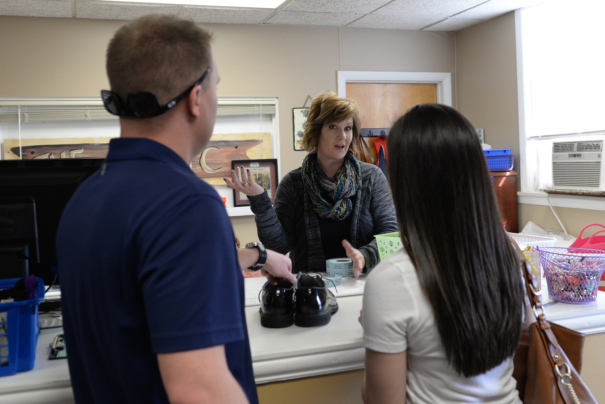 Tracy Peterson talks with customers at the Chief Master Sgt. Gene R. Collins Airman’s Attic at Scott Air Force Base, Illinois on March 12, 2015. Military members of any rank can get uniforms and books at the Airman’s Attic. Members E-4 and below and their direct dependents can get any item for free. Peterson is a core volunteer at the Airman’s Attic. (U.S. Air Force photo by Senior Airman Sarah Hall-Kirchner/Released)