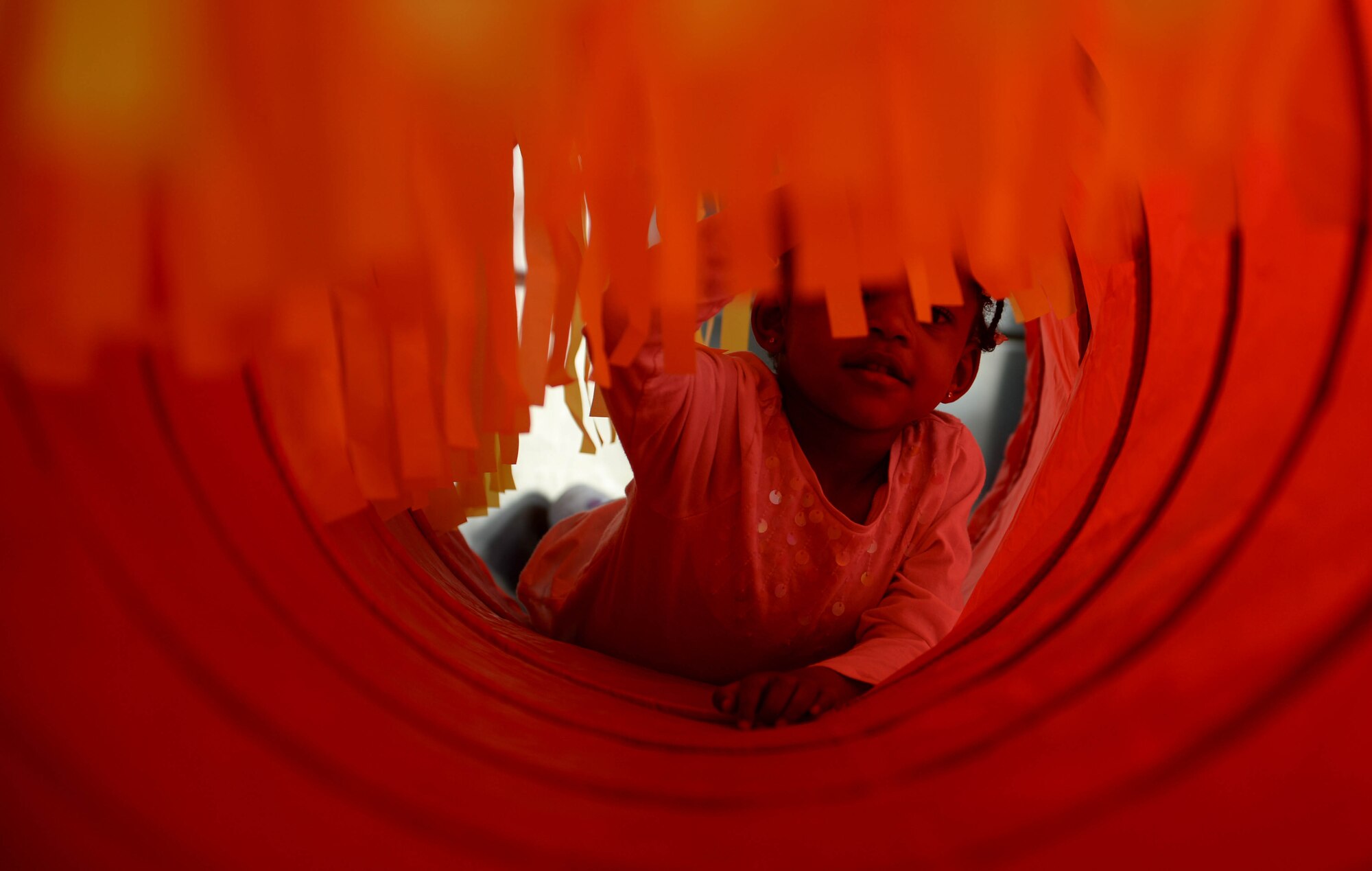 Laurel-Elaine Valerie Smith, child of Joy-Nicole Smith, crawls through a “Tickle-Me Tunnel,” one of the sensory activities available during the Exceptional Family Member Program Spring Fling at the Base Exchange at Spangdahlem Air Base, March 20, 2015. The Airman & Family Readiness Center hosted the event to raise awareness of the EFMP and the service it provides for families. The fair exposed families to the available resources and agencies available on base to aid special needs family members. (U.S. Air Force photo by Airman 1st Class Timothy Kim/Released)