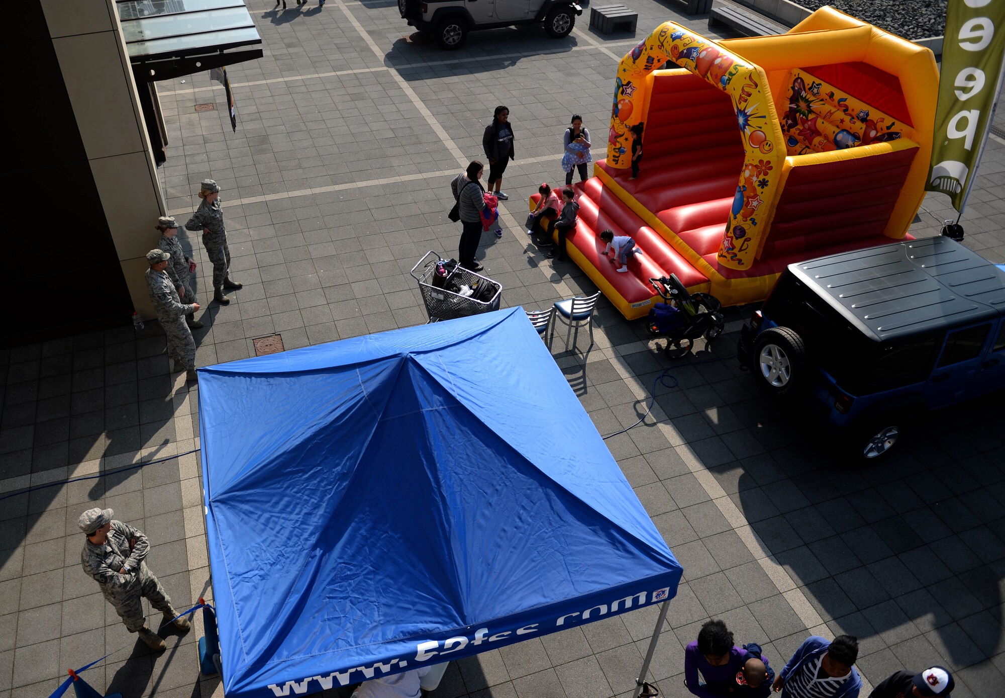 Base community members mingle during the Exceptional Family Member Program Spring Fling at the Base Exchange at Spangdahlem Air Base, March 20, 2015. The Airman & Family Readiness Center hosted the spring fling to raise awareness of the EFMP and the service it provides for families. Activities for the fair included a bouncy house, a rock-climbing wall, face-painting stations and other sensory activities that promoted exceptional family members awareness. (U.S. Air Force photo by Airman 1st Class Timothy Kim/Released)