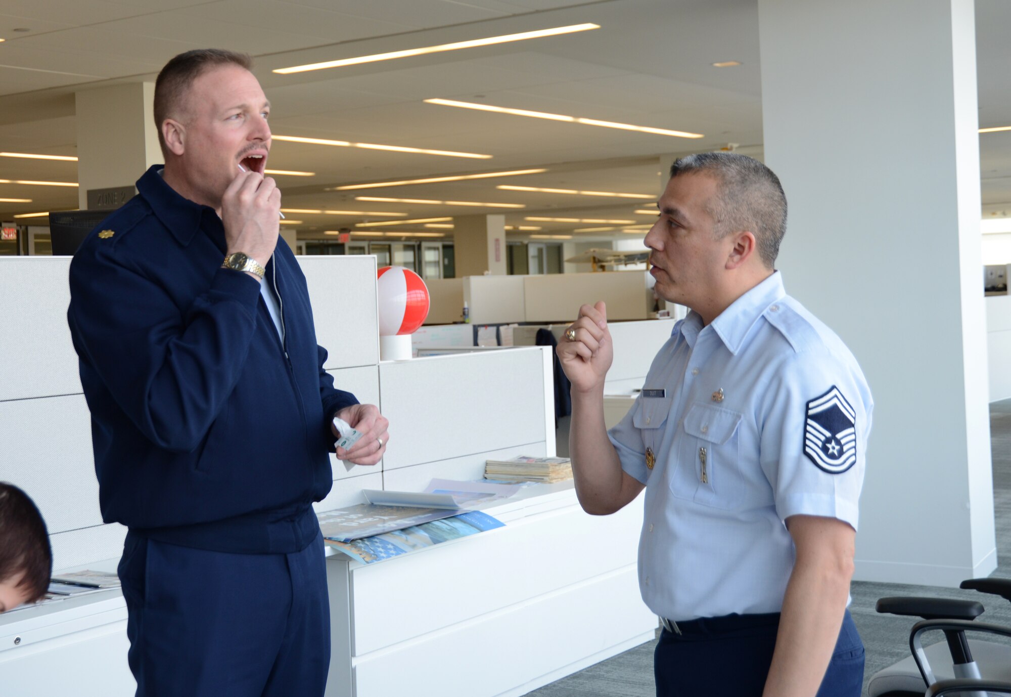 Senior Master Sgt. Paul Duit, Air National Guard Readiness Center coordinator for the Department of Defense Marrow Program guides Maj. Matthew McClurg through the donor registry process at the ANGRC on Joint Base Andrews, Md., March 19, 2015. More than 6000 people have been marrow recipients through the DoD program. (U.S. Air National Guard photo by Senior Airman John E. Hillier/Released)