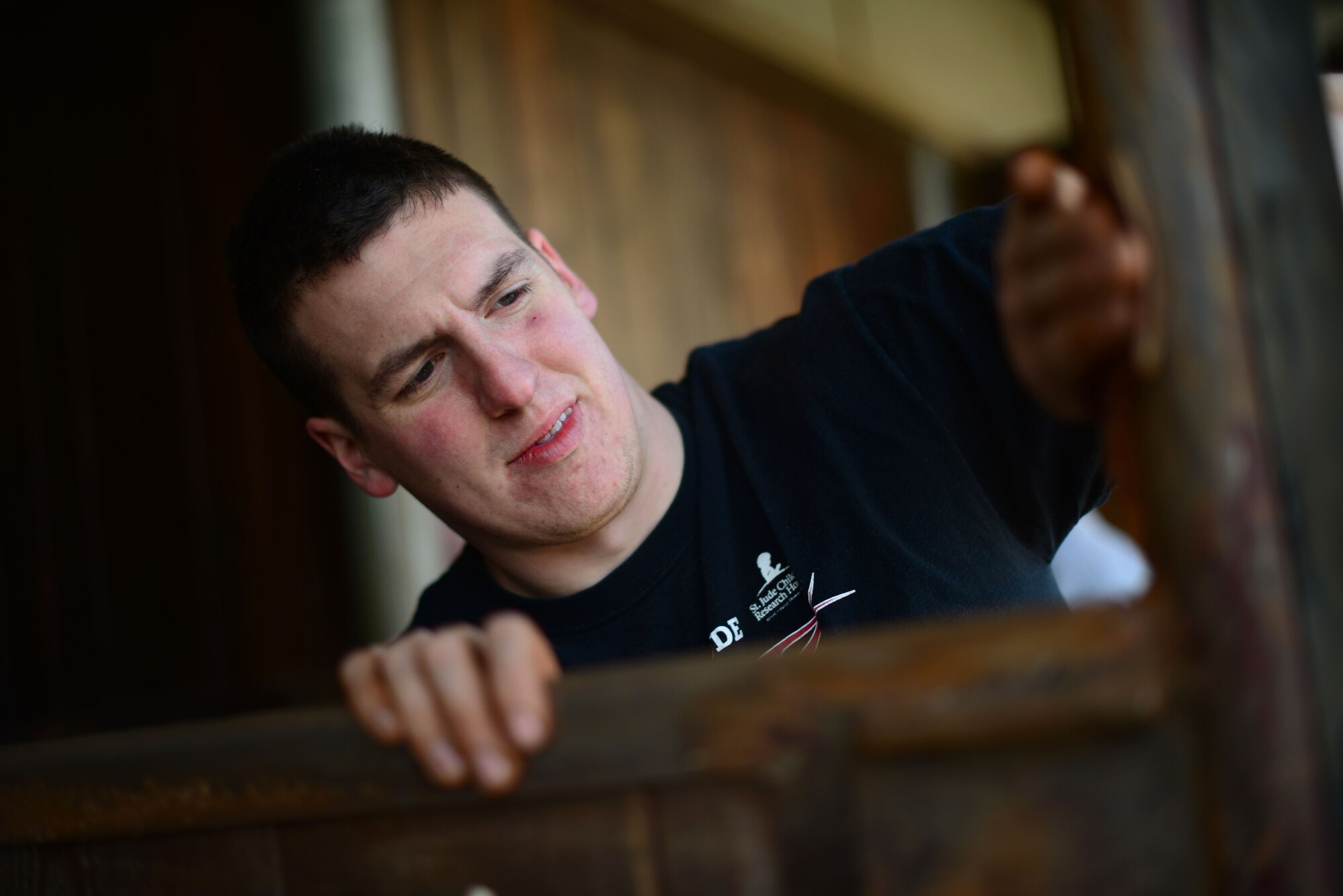 U.S. Air Force Airman 1st Class Andrew Kasperski, 31st Aircraft Maintenance Squadron phase inspection team member, sands down a horse stall before painting it March, 15, 2015 in Porcia, Italy. A group of more than 10 Airmen volunteered to help at a local a therapeutic horse-riding center. The center helps children, teenagers and adults with motor, cognitive and emotional difficulties through horse therapy. (U.S. Air Force photo by Staff Sgt. Evelyn Chavez/Released)   