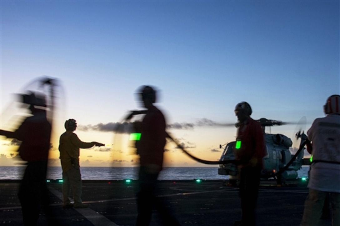 U.S. sailors on the Military Sealift Command fleet replenishment oiler USNS Amelia Earheart fuel an MH-60R Seahawk helicopter after conducting a vertical replenishment with the guided-missile destroyer USS Michael Murphy in the Philippine Sea, March 18, 2015. The helicopter is  assigned to Helicopter Maritime Strike Squadron 37.