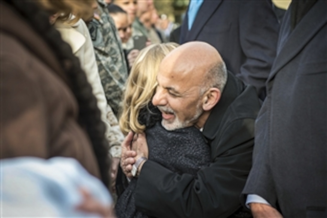 Afghan President Ashraf Ghani hugs Reese Larson, daughter of U.S. Navy Lt. Cmdr. Lonn Larson who is serving in Afghanistan, during a meeting with U.S. Defense Secretary Ash Carter at the Pentagon, March 23, 2015. During remarks in the Pentagon courtyard, Ghani thanked U.S. service members and veterans who served in Afghanistan for their efforts and sacrifices.