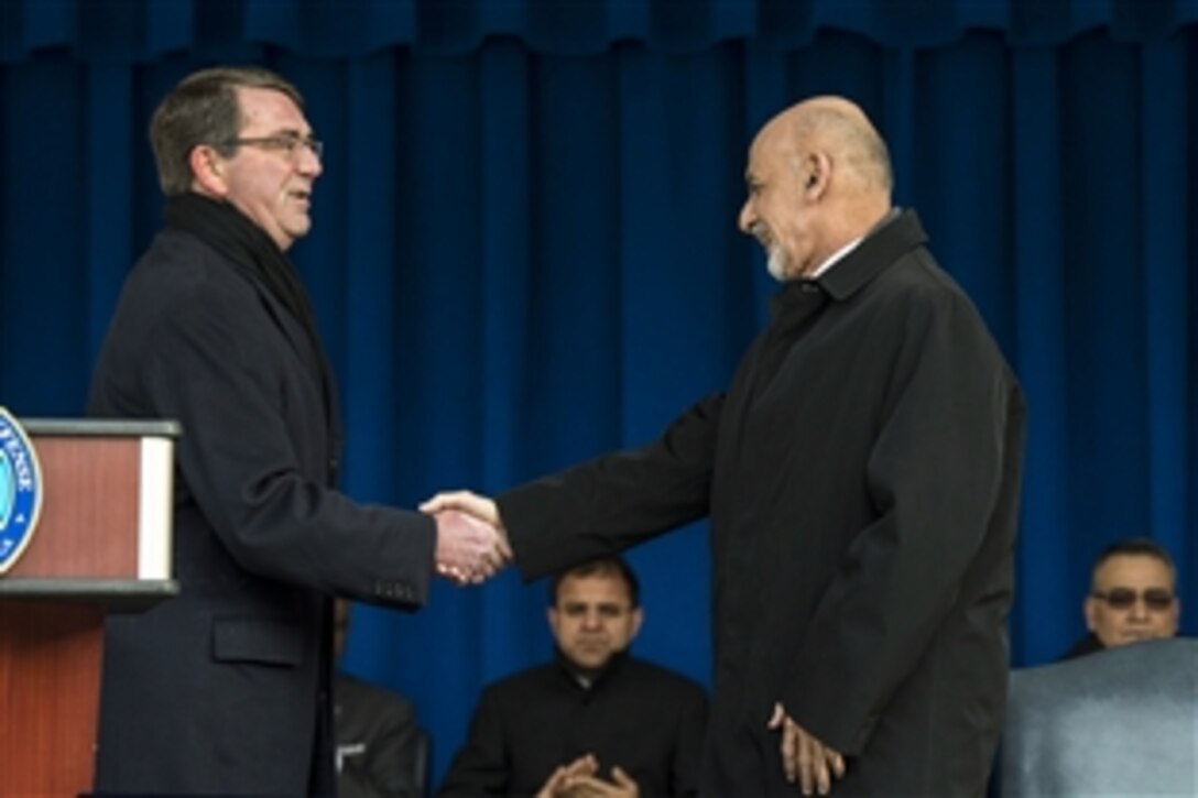 U.S. Defense Secretary Ash Carter, left, shakes hands with Afghan President Ashraf Ghani at the Pentagon, March 23, 2015. Carter hosted Ghani and Afghan Chief Executive Abdullah Abdullah for a visit. During remarks in the Pentagon's courtyard, Ghani thanked U.S. service members and veterans who served in Afghanistan for their efforts and sacrifices.