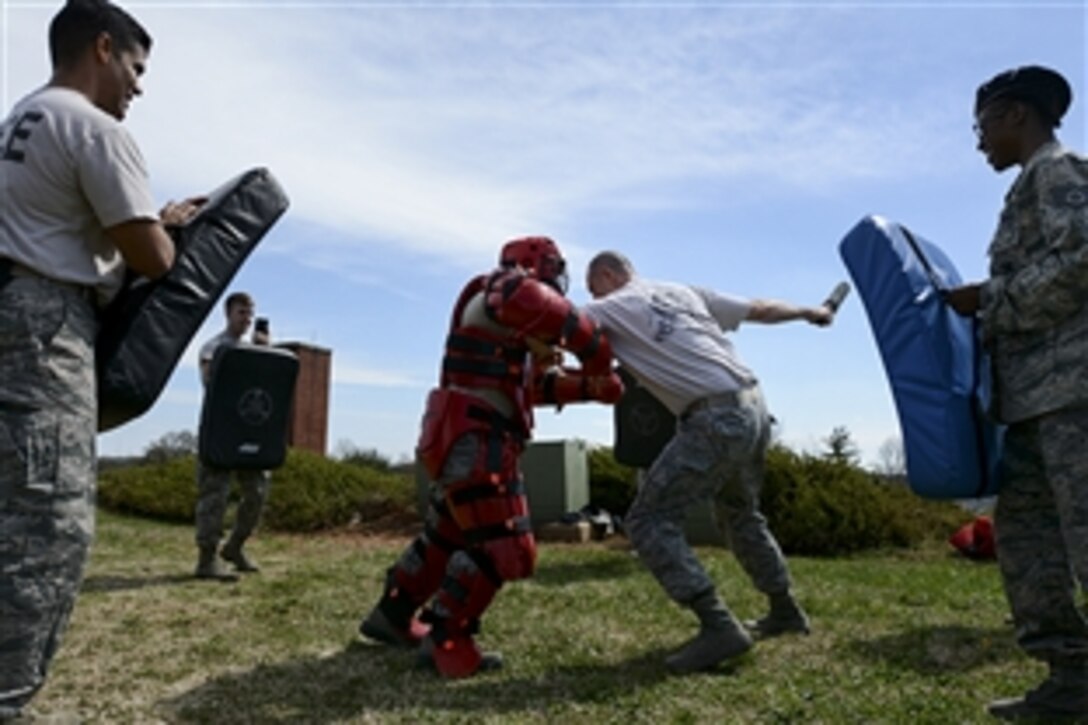 Air Force Master Sgt. Kevin Wilson, right center, fends off Staff Sgt. Anthony Capra, left center, during baton training on North Carolina Air National Guard Base at Charlotte Douglas International Airport in Charlotte, N.C., March 21, 2015. The airmen are assigned to the 145th Security Forces Squadron. 
