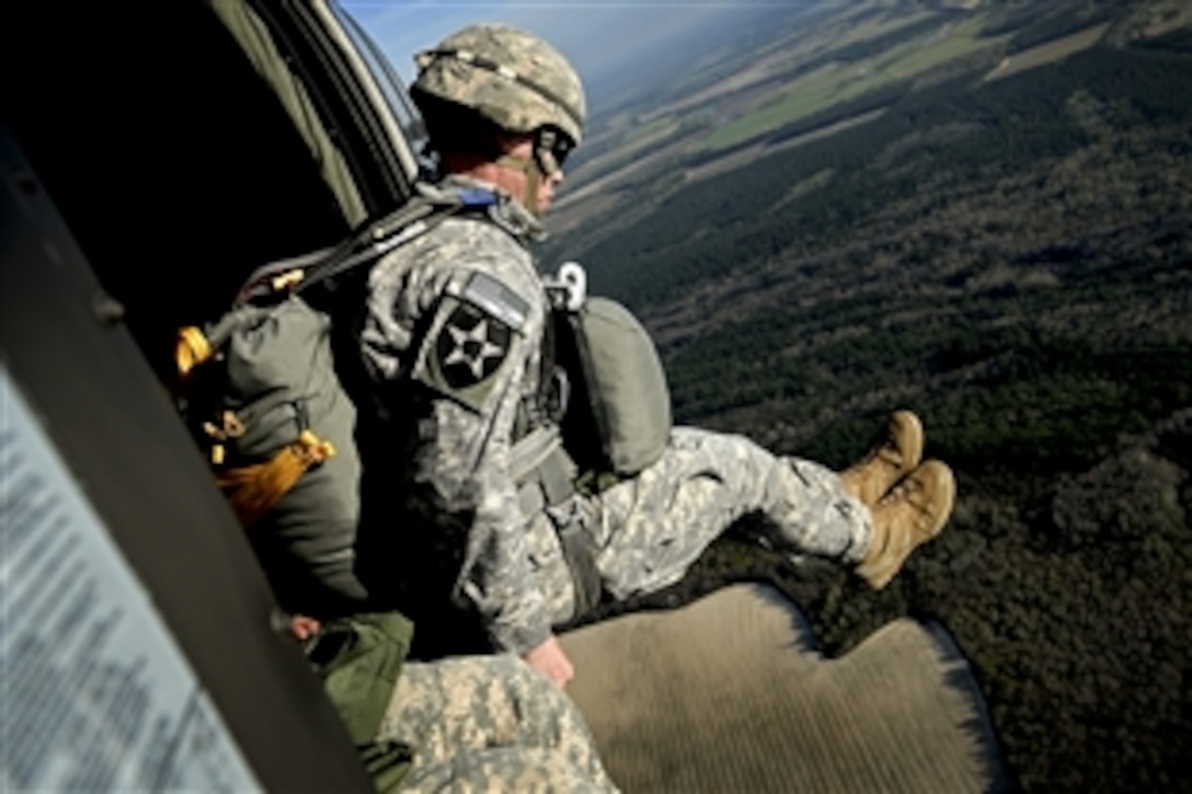 Army Maj. Stewart Brown jumps from a UH-60 Black Hawk helicopter during airborne operations in Sylvania, Ga., March 20, 2015. Brown is assigned to 55th Signal Company and the helicopter is assigned to 1st Battalion, 171st Aviation Regiment.
