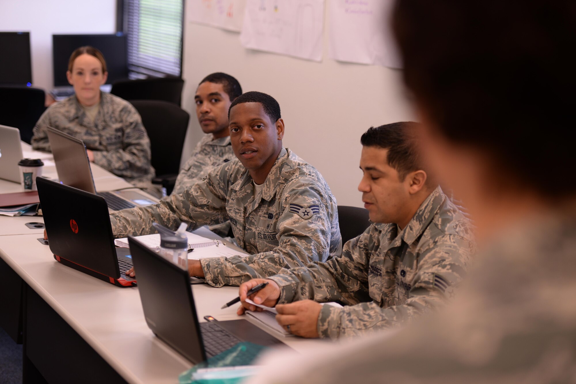 Tech. Sgt. Jamie Kienholz, non-commissioned officer in charge at Joint Base San Antonio Airman Leadership School, talks to Airmen from ALS Class 15-3 during the Introduction to Negotiation lecture at Joint Base San Antonio-Lackland, Texas, March 19, 2015. Kienholz has served as NCOIC for the past year and says the change to the developmental special duty process has brought sharp and motivated NCOs to the schoolhouse. (U.S. Air Force photo by Tech. Sgt. Joshua Strang)