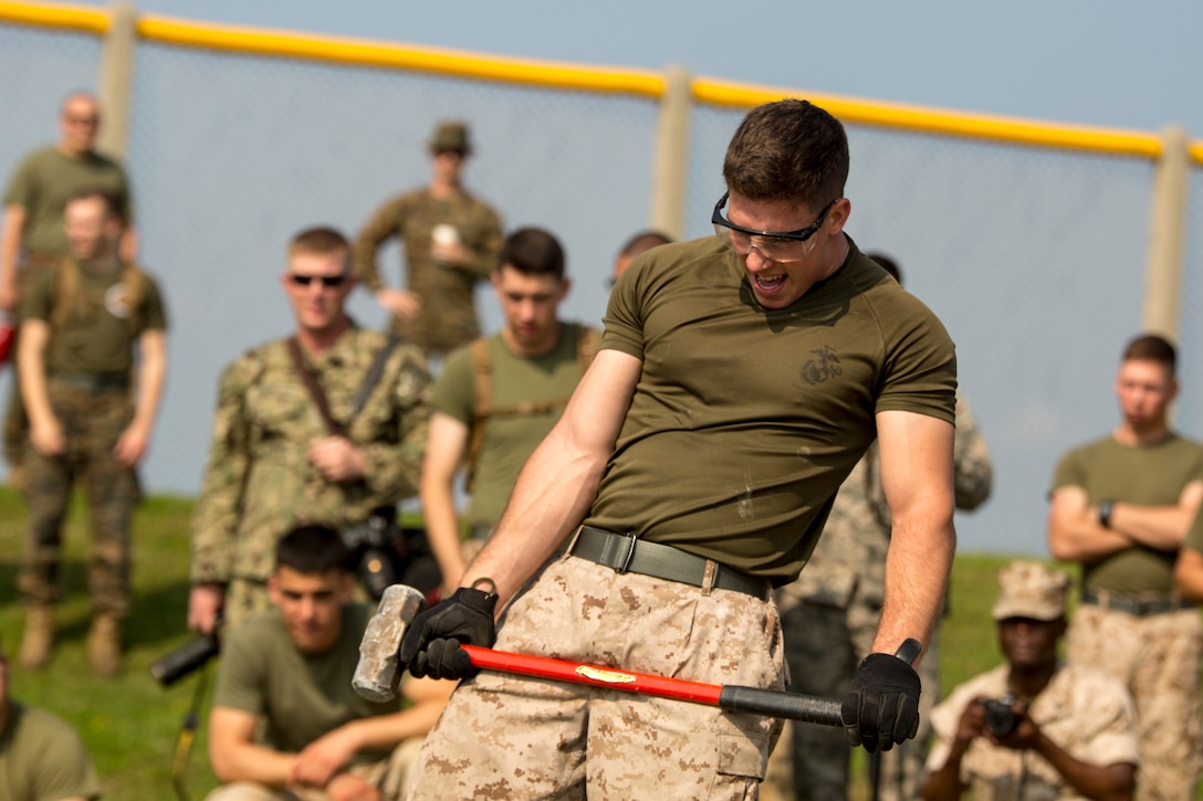 Cpl. Brian P. McLaughlin gasps for air during a find the rebar challenge March 20 at Camp Hansen, Okinawa. The event challenged teams to race against each other to see who could find a piece of rebar inside the concrete block. The challenge was part of 9th Engineer Support Battalion’s St. Patrick’s Day Engineer field meet, which consisted of several events focused on engineering skills, physical strength and endurance. Engineers from across Okinawa participated in the event while building camaraderie through competition. They also celebrated military engineers’ patron saint, St. Patrick. McLaughlin is a Wampum, Pa., native and a refrigeration and air conditioning technician with Marine Wing Support Squadron 172, Marine Wing Support Group 17, 1st Marine Aircraft Wing, III Marine Expeditionary Force.