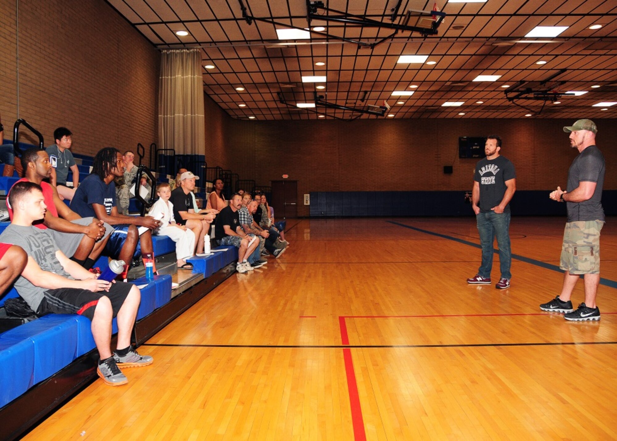 Ryan “Darth” Bader, Ultimate Fighting Champion fighter and Mike Dolce, UFC fit coach, talk with service men and women and their families Mar 21 during the UFC Fitness Tour 2015 at the Bryant Fitness Center, Luke Air Force Base, Ariz. (U.S. Air Force photo taken by Tech. Sgt. Louis Vega Jr.)
