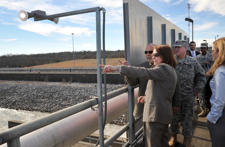 From the top of the U.S. Army Corps of Engineers' dam at Stennis Lock on the Tennessee-Tombigbee Waterway in Mississippi, Hon. Jo-Ellen Darcy, Assistant Secretary of the Army for Civil Works, asks lock operations manager Rickey Saucer about the lighting in the dam recreation area parking lot. Darcy and Kate Brandt, Federal Environmental Executive, White House Council of Environmental Quality, visited the Mobile District lock and dam Jan. 21 to learn about their energy and sustainability efforts with the U.S. Army Engineering and Support Center, Huntsville. Through the first-ever Energy Savings Performance Contract for a civil works project managed by Huntsville Center, Mobile District is retrofitting and replacing lighting at 46 locations along the 234-mile waterway, which will result in guaranteed savings of more than $172,700 in the first year alone. 