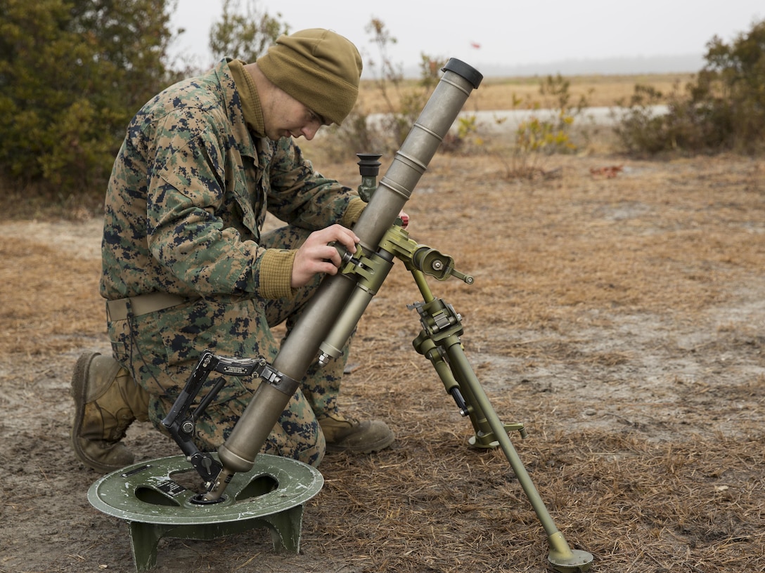 PFC Jacob T. Durden, a mortar man with Alpha Company, 1st Battalion, 2nd Marine Regiment, adjusts the aim on a M224 60mm lightweight mortar during practice exercises as a part of a battalion field exercise aboard Camp Lejeune, North Carolina, March 4, 2015. The mortar men conducted drills to better familiarize the newer Marines with their weapon systems. (U.S. Marine Corps photo by Lance Cpl. Olivia McDonald/Released)