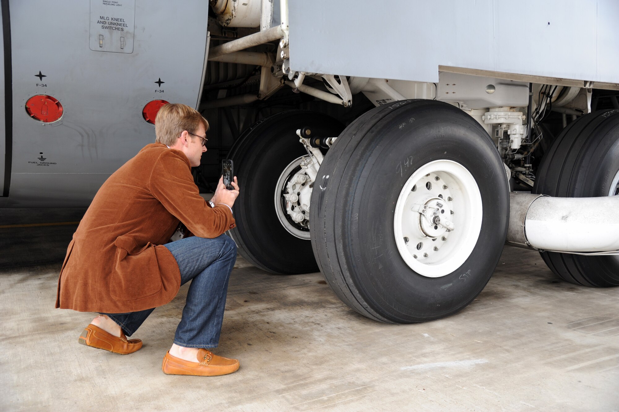 Greg Holden the vice president of Manning and Napier Advisors, inspects the landing gear of a C-5 Galaxy cargo plane during a 927th Air Refueling Wing, MacDill Air Force Base, Florida, sponsored civic leader trip to the 433rd Airlift Wing, Joint Base San Antonio, Texas, March 19-20. Civic leader trips increase awareness of how the Air Force Reserve contributes to the total force and the importance of the 927th Air Refueling Wing to the local economy. (U.S. Air Force photo/Tech. Sgt. Peter Dean) 
