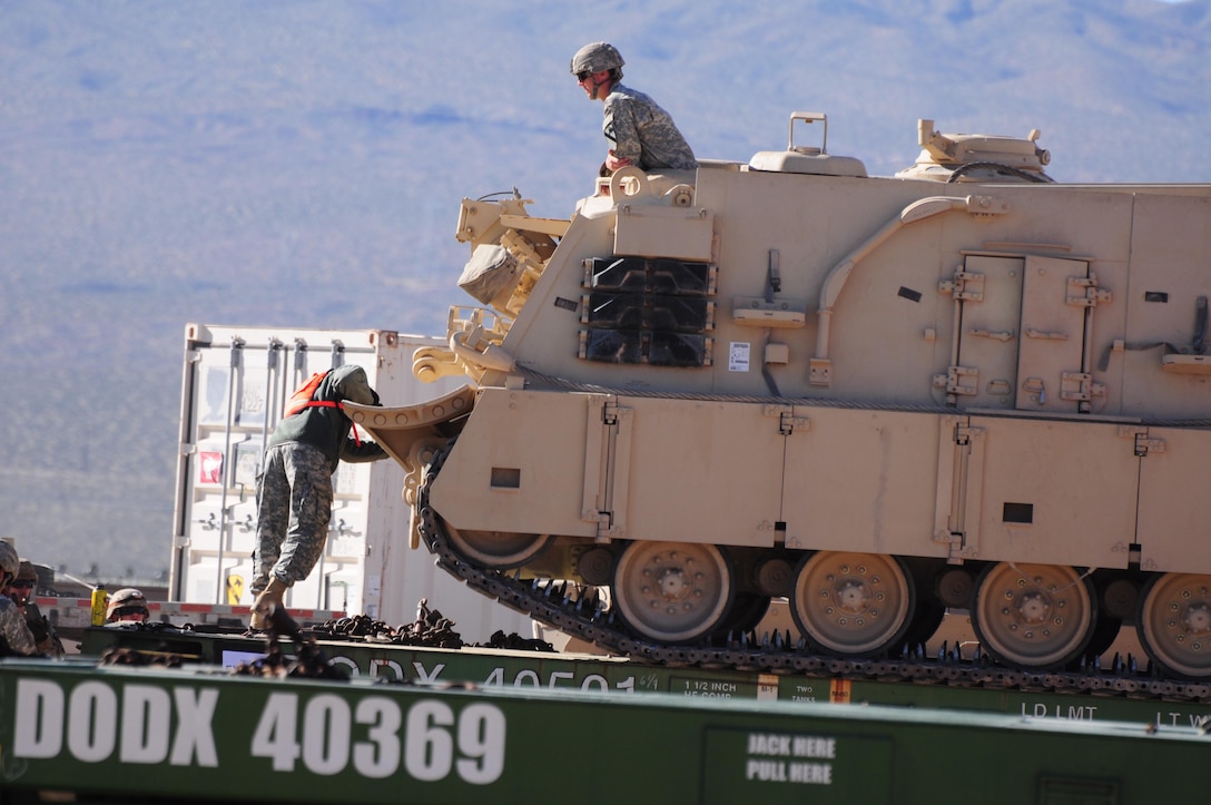 Heading to the National Training Center at Fort Irwin, Calif., the 1st Infantry Division out of Fort Riley, Kan. unloads heavy equipment from railcars at Yermo Annex, Marine Corps Logistics Base Barstow, Calif., while the First Cavalry Division out of Fort Hood, Tex. loads its equipment onto trains following combat training at NTC.  MCLB Barstow possesses the largest Department of Defense railhead in the world.