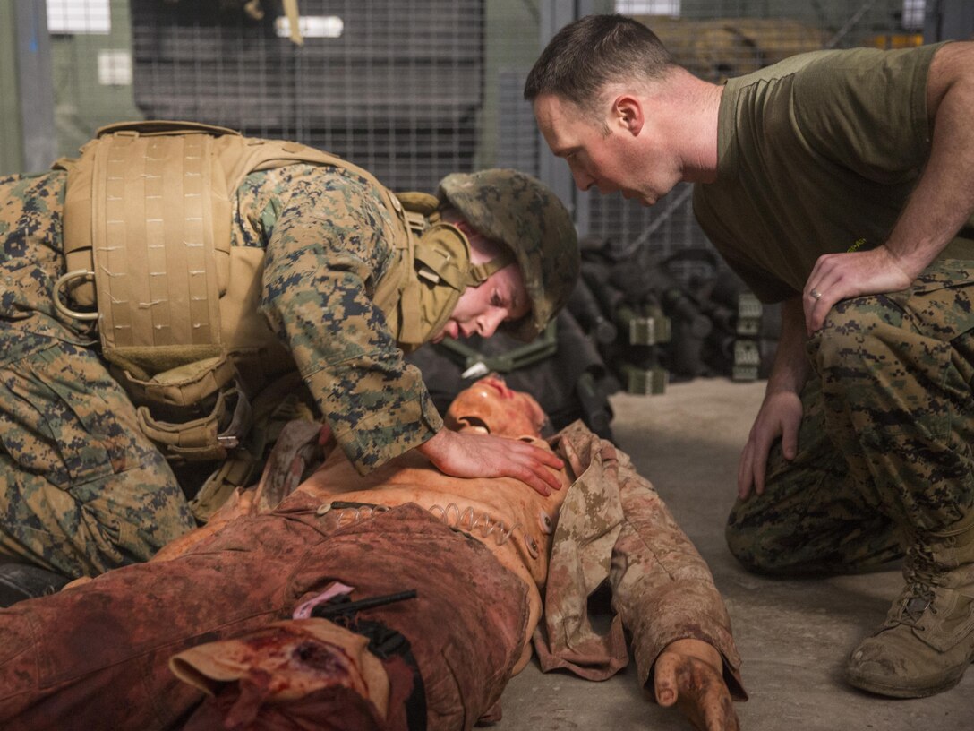 PO2 James Gafford, an instructor with 2nd Medical Battalion, II Marine Expeditionary Force, creates anxiety for a Marine treating the simulated casualty during the testing phase of a four-day Combat Life Savers class aboard Camp Lejeune, N.C., March 5 2015. Marines in the class were taught emergency combat medicine with the intent that in a casualty situation they can apply lifesaving procedures in the case a corpsman cannot reach the wounded. (U.S. Marine Corps photo by Lance Cpl. Olivia McDonald/Released)