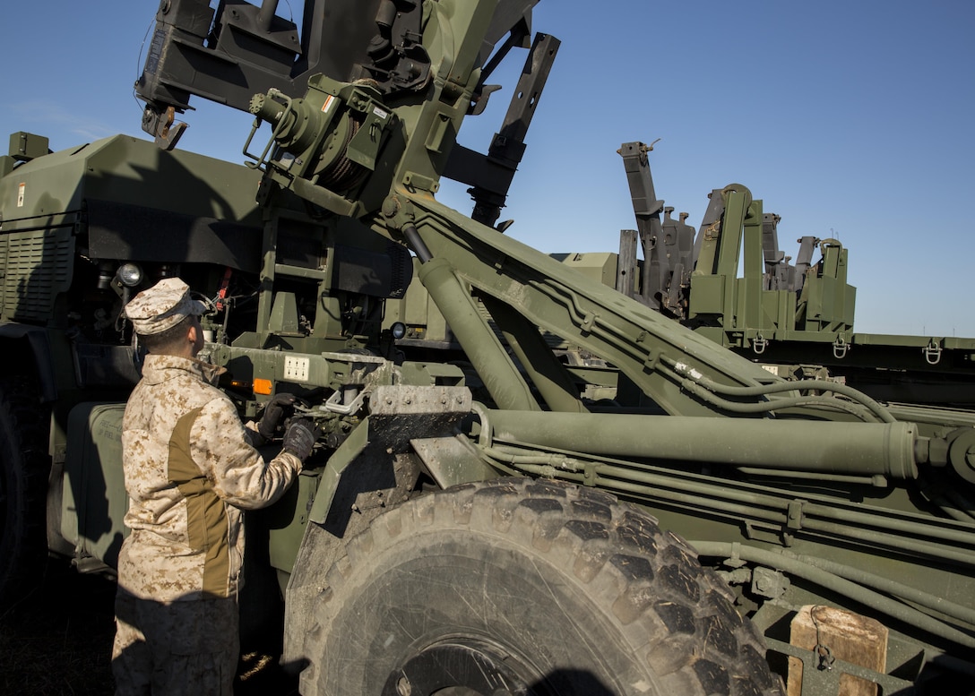 Lance Cpl. Davey R. Scarbrough, a motor vehicle operator with 8th Communication Battalion, II Marine Expeditionary Force, operates the hydraulics on the back of a Logistics Vehicle System Replacement MKR-18 Cargo during 8th Comm.’s field exercise aboard Camp Lejeune, N.C., March 12, 2015. The LVSR MKR-18 is a multi-wheeled vehicle capable of carrying storage containers on the back. (U.S. Marine Corps photo by Cpl. Justin T. Updegraff/ Released)