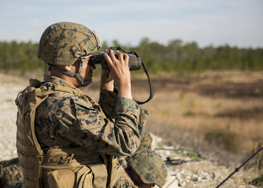 Private first class Michael P. Dunlap, a fire support man with 2nd Air Naval Gunfire Liaison Company, II Marine Expeditionary Force Headquarters Group, finds the range of his target using the Vector 21-B during a call for fire exercise aboard Camp Lejeune, N.C., March 17, 2015. The Marines worked on small team maneuvers by conducting a patrol out to the range, followed by selecting and occupying a portion of the range, setting up security and conducting call for fire procedures. (U.S. Marine Corps photo by Cpl. Justin T. Updegraff/ Released)