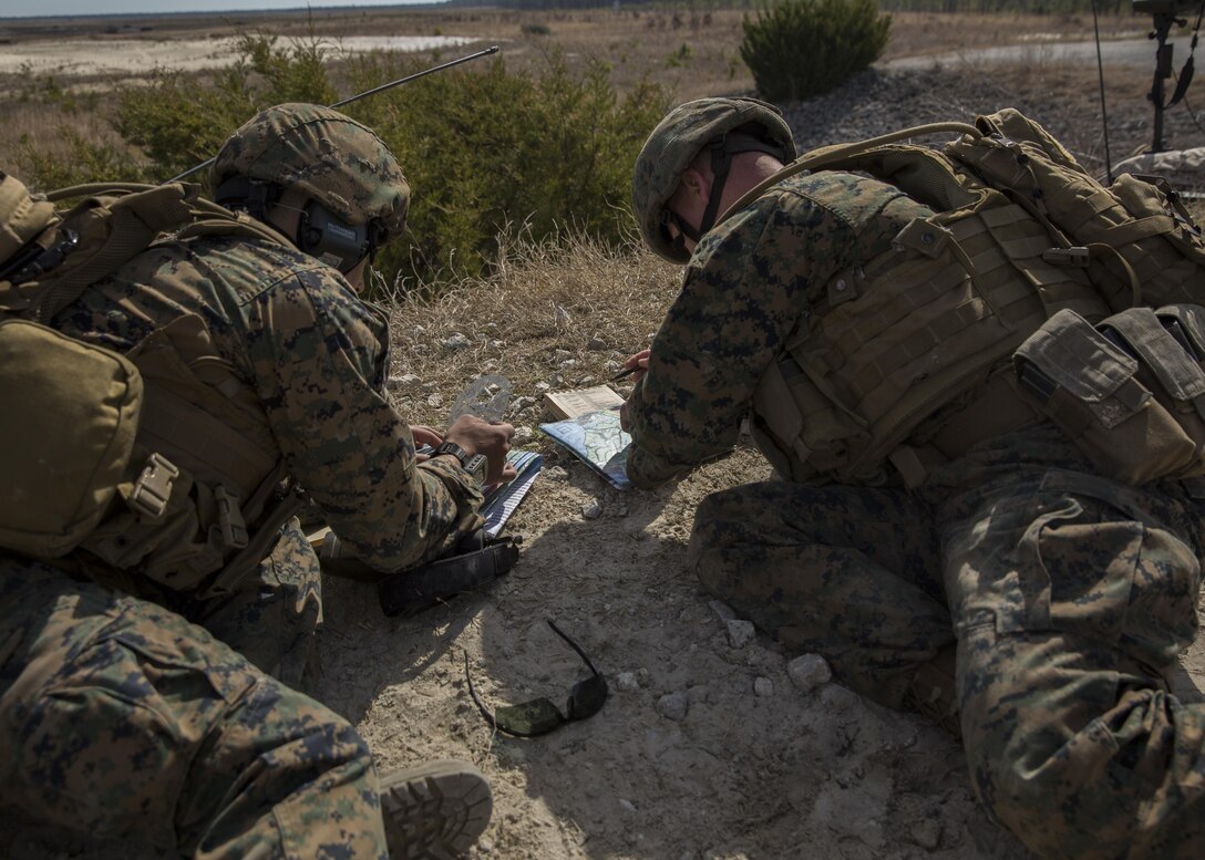 Sgt. Victor J. Lopez, left, a fire support man with 2nd Air Naval Gunfire Liaison Company, II Marine Expeditionary Force Headquarters Group, assists another Marine to ensure he knows how to correctly call for fire over the radio during an exercise aboard Camp Lejeune, N.C., March 17, 2015. Marines also practiced establishing communication with their higher headquarters, troubleshooting and maintaining communication to receive follow on tasks for the next mission. (U.S. Marine Corps photo by Cpl. Justin T. Updegraff/ Released)