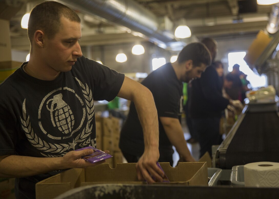 Cpl. Joshua Saffady, a corrections specialist with Special-Purpose Marine Air-Ground Task Force-Boston, sorts donated food while volunteering at The Greater Boston Food Bank in South Boston, March 17, 2015. Marines and sailors with SP-MAGTF organized and packaged more than 15,000 pounds of food during their visit to the food bank, providing 10,137 meals to people in need in the greater Boston area. (U.S. Marine Corps photo by Lance Cpl. Olivia McDonald/Released)


