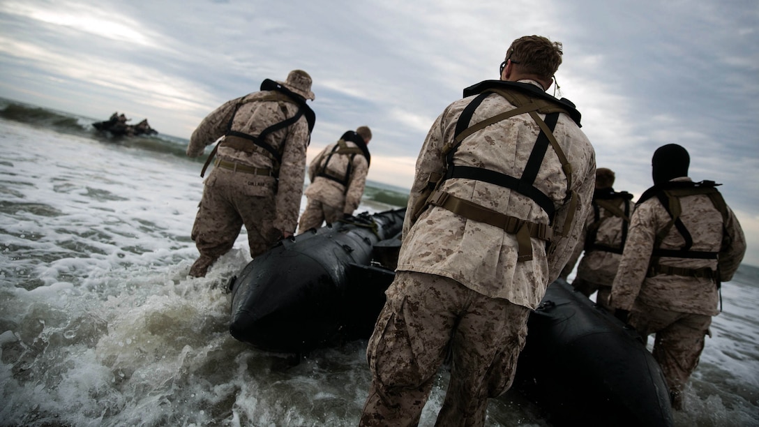 Marines with 2nd Reconnaissance Battalion, 2nd Marine Division, press forward into the Atlantic Ocean during an amphibious beach exercise at Onslow beach, aboard  Camp Lejeune, N.C., March 19, 2015 . The land navigation process started with driving from one known to point to another, calculating the speed and using it to drive the boat on water. 