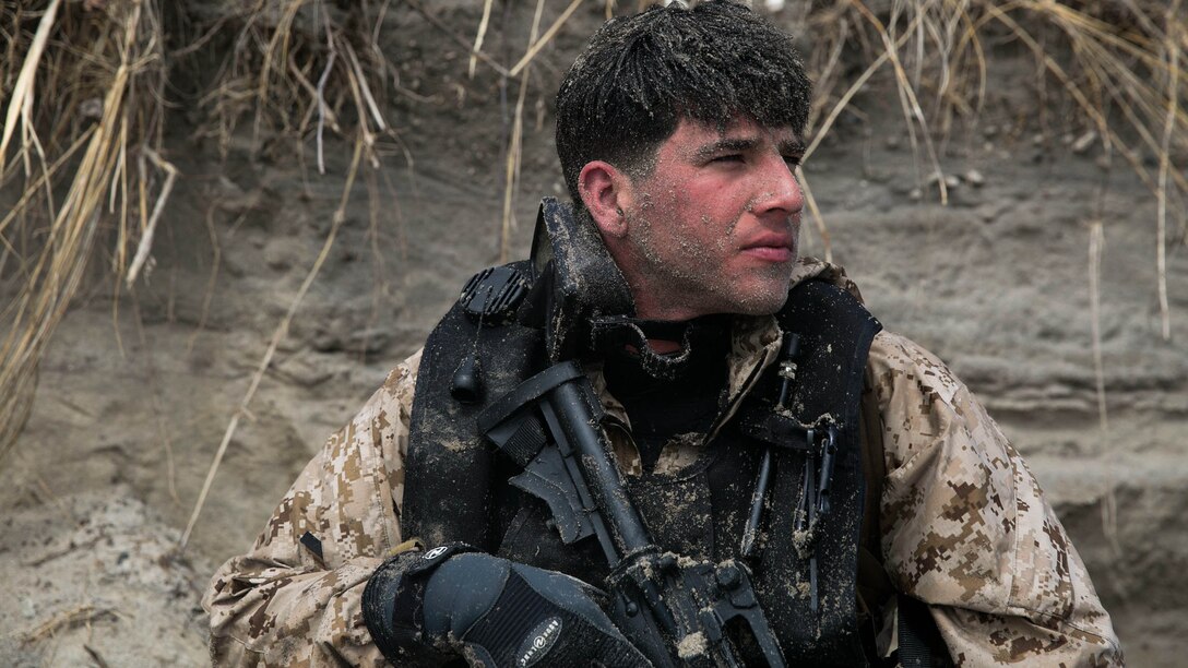 Cpl David Elliot, A Marine with 2nd Reconnaissance Battalion, 2nd Marine Division observes the beach for anomalies during an amphibious beach exercise at Onslow beach, aboard  Camp Lejeune, N.C., March 20, 2015. Scout swimmers are dropped off about 500 meters away from the shore, where they swim in and secure a landing zone, and signal the boat teams to land on shore at the same time. 