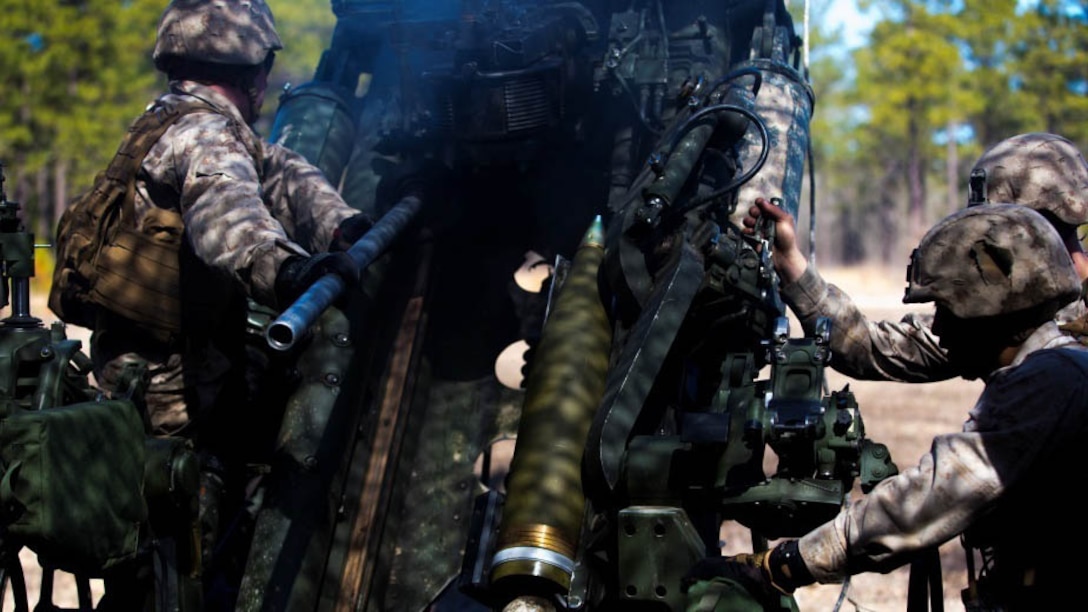 Marines with Fox battery, 2nd Battalion, 10th Marine Regiment, 2nd Marine Division place a round inside a howitzer preparing to fire during Exercise Rolling Thunder aboard Fort Bragg, N.C., March 7, 2015. The importance of Rolling Thunder is training Marines to execute effective fire missions during combat operations.