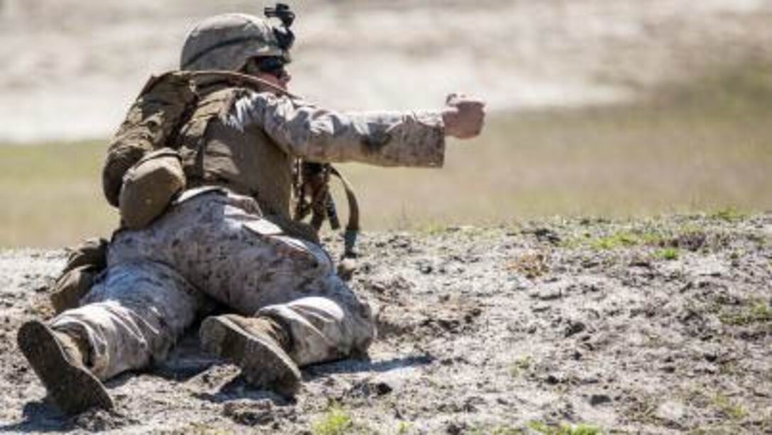 A fire-team leader with Charlie Company, 1st Battalion, 6th Marine Regiment calls for members of his fire-team to advance during a live-fire, fire-team attack range exercise aboard Camp Lejeune, N.C., March 18, 2015. The attack was used to prepare Marines for future training engagements and ultimately deployments, where they will operate at squad and platoon levels. 