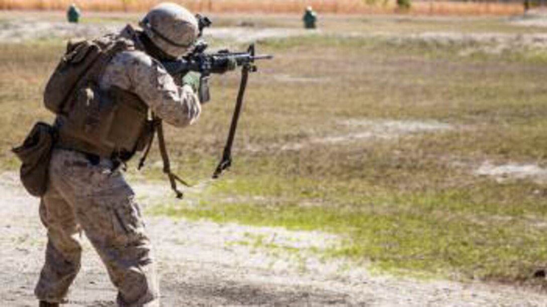 A Marine with Charlie Company, 1st Battalion, 6th Marine Regiment fires his M16 A-4 service rifle at targets from an unknown distance prior to a live-fire, fire-team attack range exercise aboard Camp Lejeune, N.C., March 18, 2015. Marines with the company fired at targets in the standing, kneeling, and prone positions to maintain basic firing fundamentals prior to adding in the challenges of taking ground and providing suppressive fire for their fellow team members. 