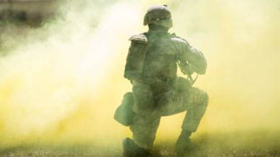 A Marine with Charlie Company, 1st Battalion, 6th Marine Regiment prepares to advance through a cloud of smoke during a live-fire, fire-team attack range exercise aboard Camp Lejeune, N.C., March 18, 2015. One fire team at a time conducted the attack, advancing across a field while providing suppressive fire and utilizing various munitions. 