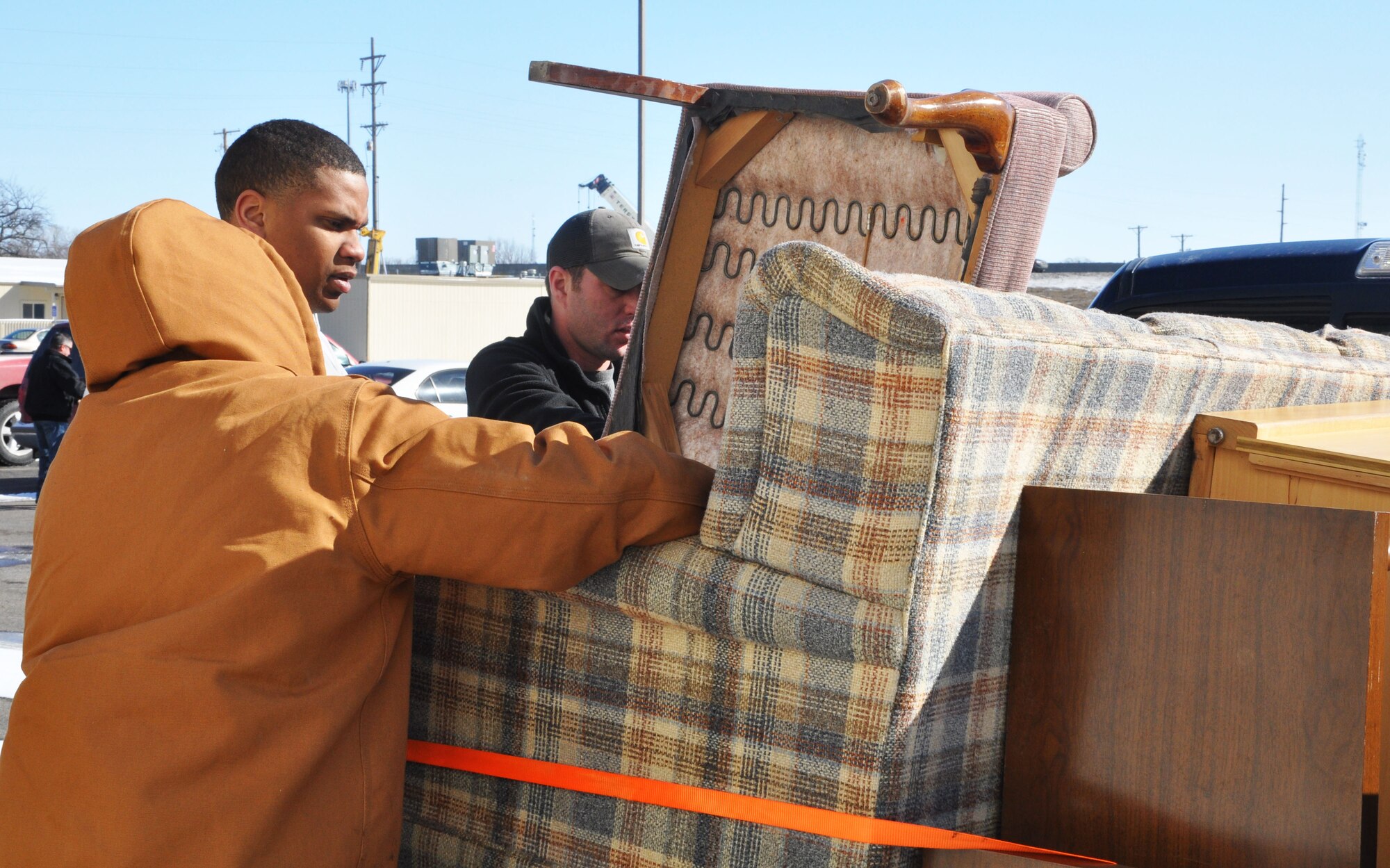 Volunteers from McConnell arrange furniture into the back of a truck outside of a warehouse at His Helping Hands, a local non-profit that distributes household items to families in need in Wichita, Kan., March 5. The VA in Wichita works with His Helping Hands to provide household goods for homeless veterans as part of their initiative to end homelessness. (U.S. Air Force photo by Tech. Sgt. Abigail Klein) 
