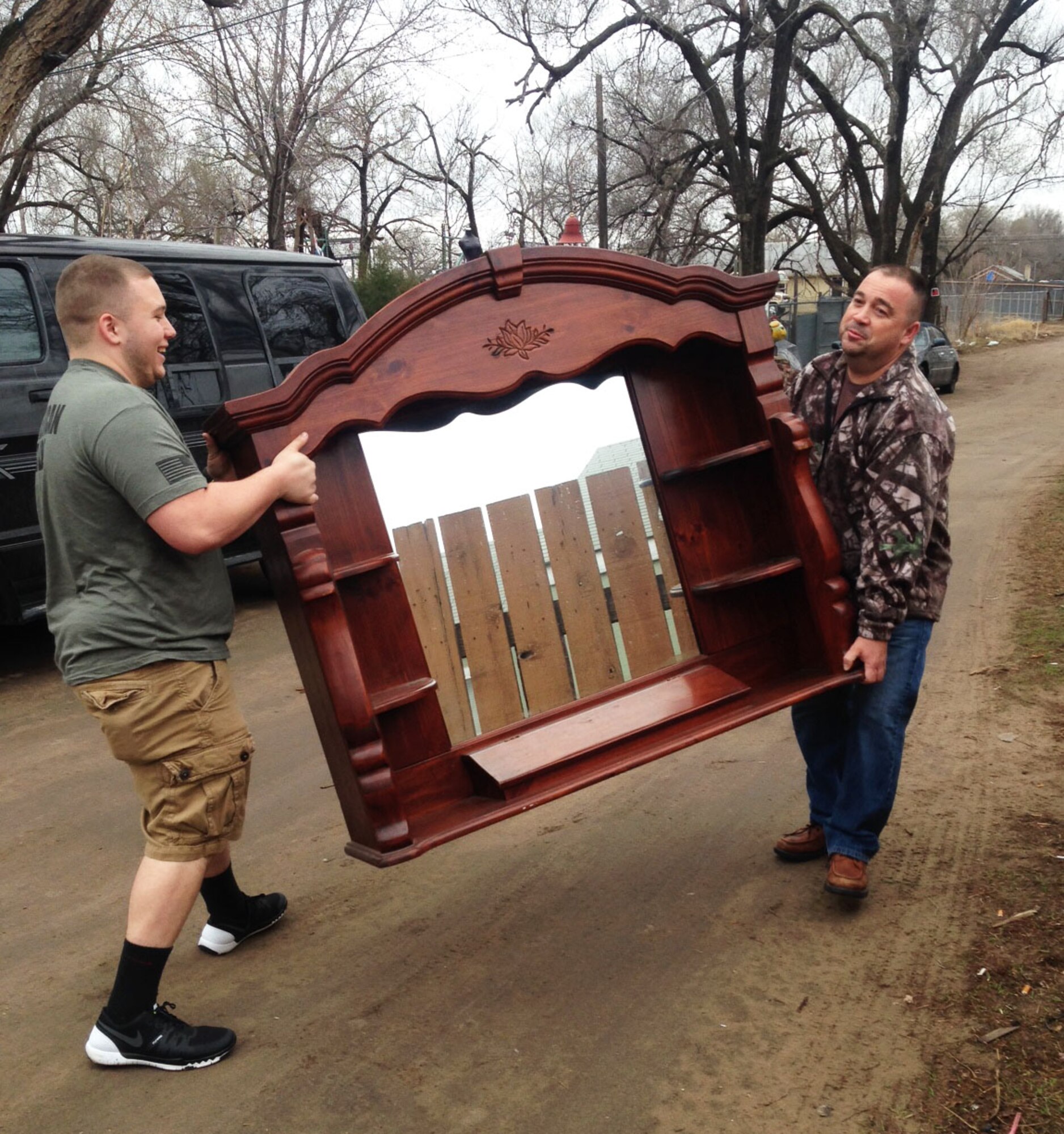 Christian Peel and his father, Senior Master Sgt. Eric Peel, 931st Aircraft Maintenance Squadron production superintendent, carry part of a bedframe for a veteran moving into new housing in Wichita, Kan., March 19, 2015. McConnell Airmen, the Robert J. Dole Veterans Administration Medical Center and His Helping Hands, a local non-profit, are all working together to end veteran homelessness. (U.S. Air Force photo by Tech. Sgt. Abigail Klein) 
