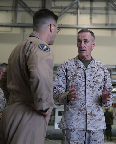 Gen. Joseph Dunford, Commandant of the Marine Corps, talks to Lt. Col. Shawn Basco, commanding officer of Marine All-Weather Fighter Attack Squadron 242, during his visit to Marine Corps Air Station Iwakuni, Japan, March 24, 2015. Dunford and Sgt. Maj. Ronald Green, Sergeant Major of the Marine Corps, spent their visit speaking to service members on the future of the Marine Corps and answered any questions they had.