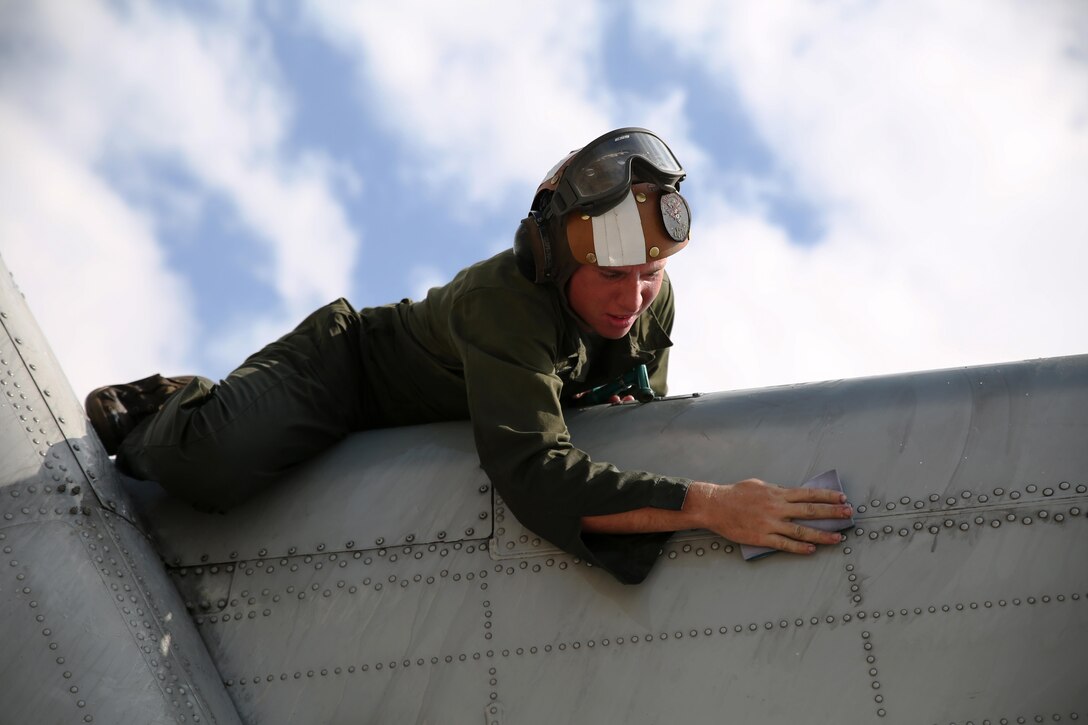 Lance Cpl. Aaron Neefe, an aviation mechanic with Marine Heavy Helicopter Squadron 463, washes the tail of a CH-53E Super Stallion helicopter March 17, 2015, in preparation for an inspection aboard Marine Corps Base Hawaii. The unit prepared five CH-53Es to send to Marine Rotational Force Darwin, Australia later this year. It takes 1,500 man-hours per aircraft to make the aircraft inspection-ready for the deployment.