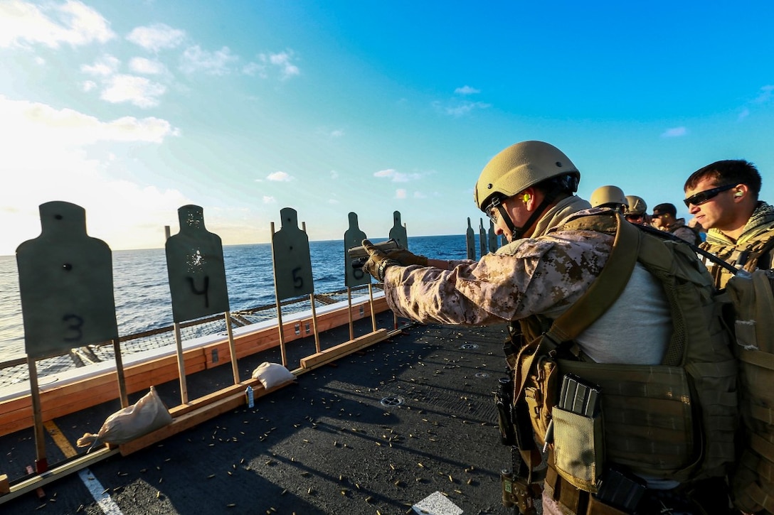 U.S. Marines with the 15th Marine Expeditionary Unit's Maritime Raid Force, fire their M1911 .45 caliber pistols during Composite Training Unit Exercise (COMPTUEX) aboard the USS Anchorage (LPD 23) off the coast of San Diego March 23, 2015. The 15th MEU's MRF Marines constantly sharpen their skills with different weapon systems to maintain a high level of readiness. (U.S. Marine Corps photo by Sgt. Jamean Berry/Released)