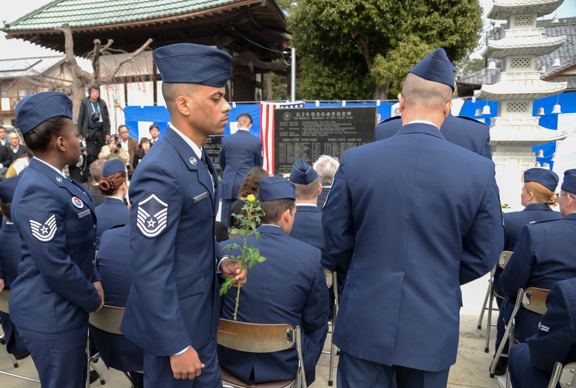 Airmen from Yokota Air Base, Japan, wait in a line to pay their respects to the 23 fallen Airmen at the B-29 memorial ceremony in Gunma Prefecture, Japan, March 21, 2015. To honor those that lost their lives, the Airmen laid down a flower and rendered a salute. Yokota Airmen have been participating in B-29 ceremonies since 1971. (U.S. Air Force photo by Senior Airman Mi-chael Washburn/Released)