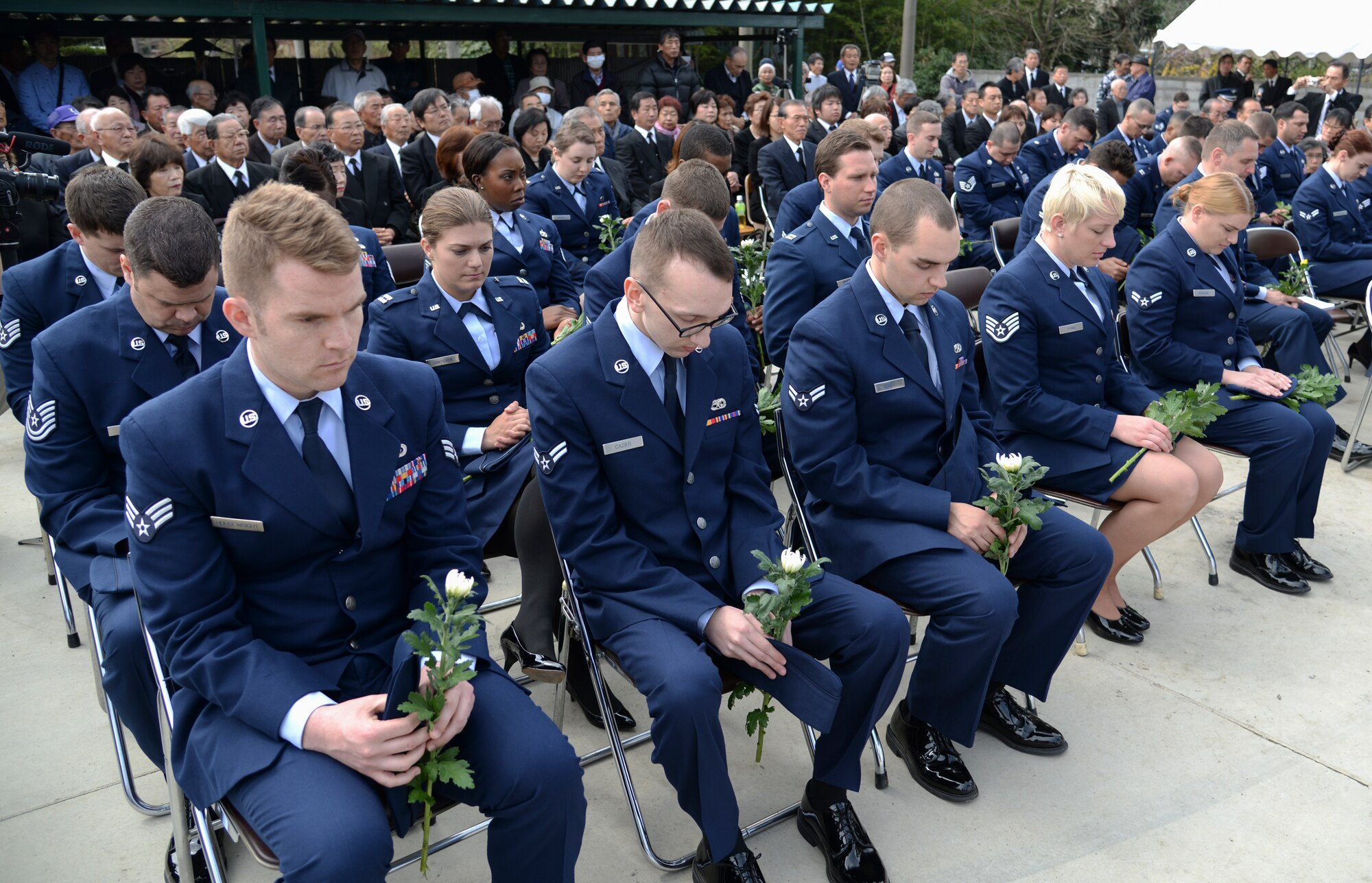 Air Force service members bow their heads as Chaplain (Lt. Col.) David Mansberger, 374th Airlift Wing chaplain, delivers an invocation during the B-29 memorial ceremony in Gunma Prefecture, Japan, March 21, 2015. The ceremony was held by Shinyu Kizaki, the temple priest at Seiganji Shrine. Kizaki was 12 years-old when the two B-29s crashed in 1945. (U.S. Air Force photo by Senior Airman Michael Washburn/Released)