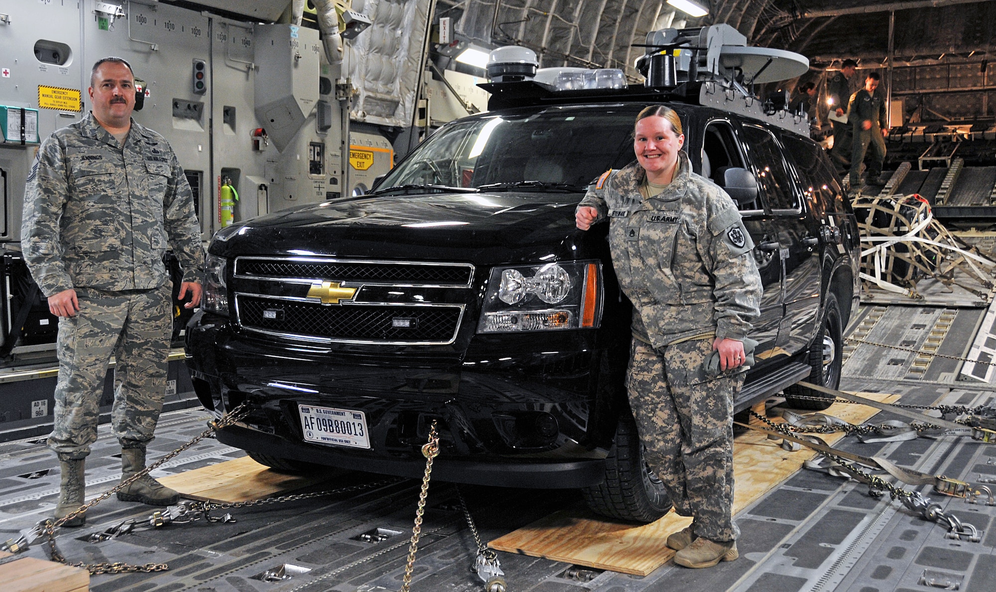 Air Force Senior Master Sgt. John Jennings Jr., Alaskan Command superintendent, command, control, communications and computer systems plans and future operations, and Army Staff Sgt. Lacey Steward, ALCOM command, control, communications and computer systems deployable communications NCO in charge, pose with ALCOM’s emergency response vehicle in a C-17 prior to takeoff March 19, 2015. The team flew to Homer, Alaska, to provide defense support of civil authorities in Exercise Rock in a Hard Place. The ERV provided emergency 72-hour information technology services for a disaster response exercise. The exercise scenario called for state and federal resources respond to assist the community of Homer and the Kenai Borough following a significant mudslide that damaged the South Peninsula Hospital and severed road and communications lines. (U.S. Air Force photo/Tech. Sgt. John Gordinier)