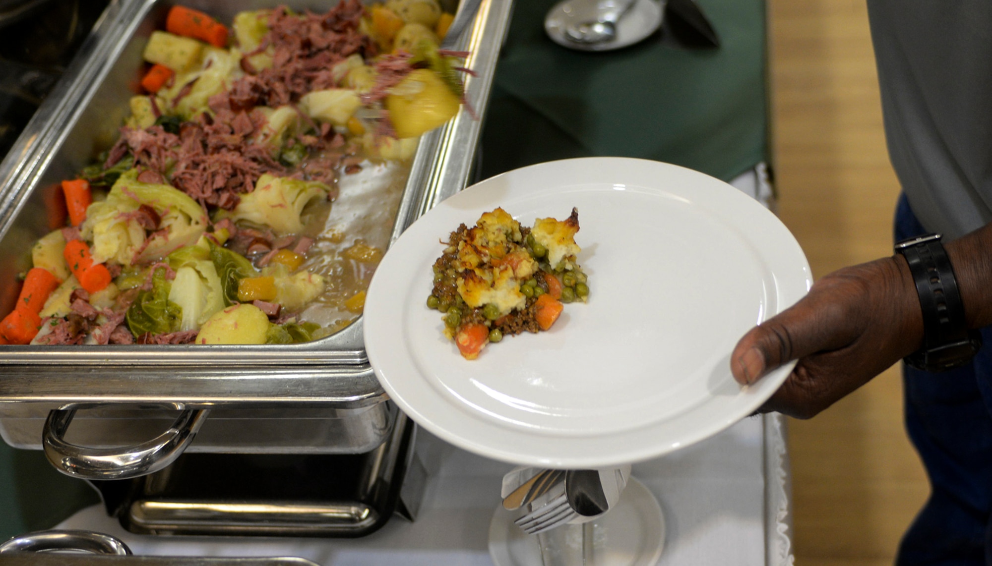 A Moody Field Club customer gets Sheppard’s pie during the Luck of the Irish Lunch Buffet March 18, 2015, at Moody Air Force Base, Ga.  MFC employees wrote the menu in English and Gaelic- a language traditionally spoken in Ireland. (U.S. Air Force photo by Senior Airman Sandra Marrero/Released)
