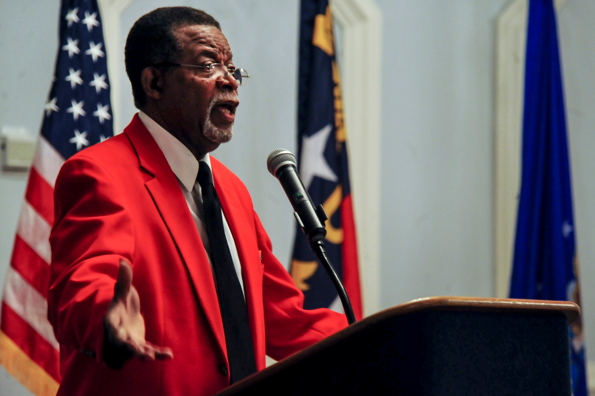 Retired Maj. Roy White, Eagleson Chapter vice president and historian, speaks with Airmen during a heritage luncheon, March 18, 2015, at Seymour Johnson Air Force Base, North Carolina. White told the story of how the Tuskegee Airmen broke through not only racial barriers on the home front, but also through Germany's air superiority that held through most of the war. (U.S. Air Force photo/Senior Airman Brittain Crolley)