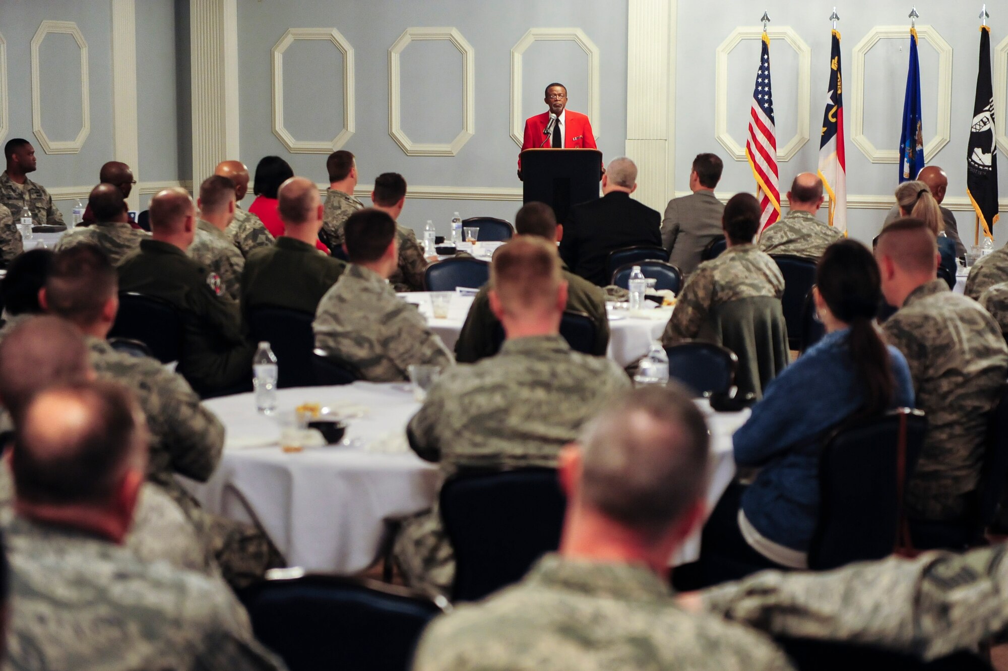 Retired Maj. Roy White, Eagleson Chapter vice president and historian, speaks with Airmen during a heritage luncheon, March 18, 2015, at Seymour Johnson Air Force Base, North Carolina. White highlighted the event as the keynote speaker and shared his account of working with this resilient group of standout Airmen - simply known as the "Red Tails". (U.S. Air Force photo/Senior Airman Brittain Crolley)